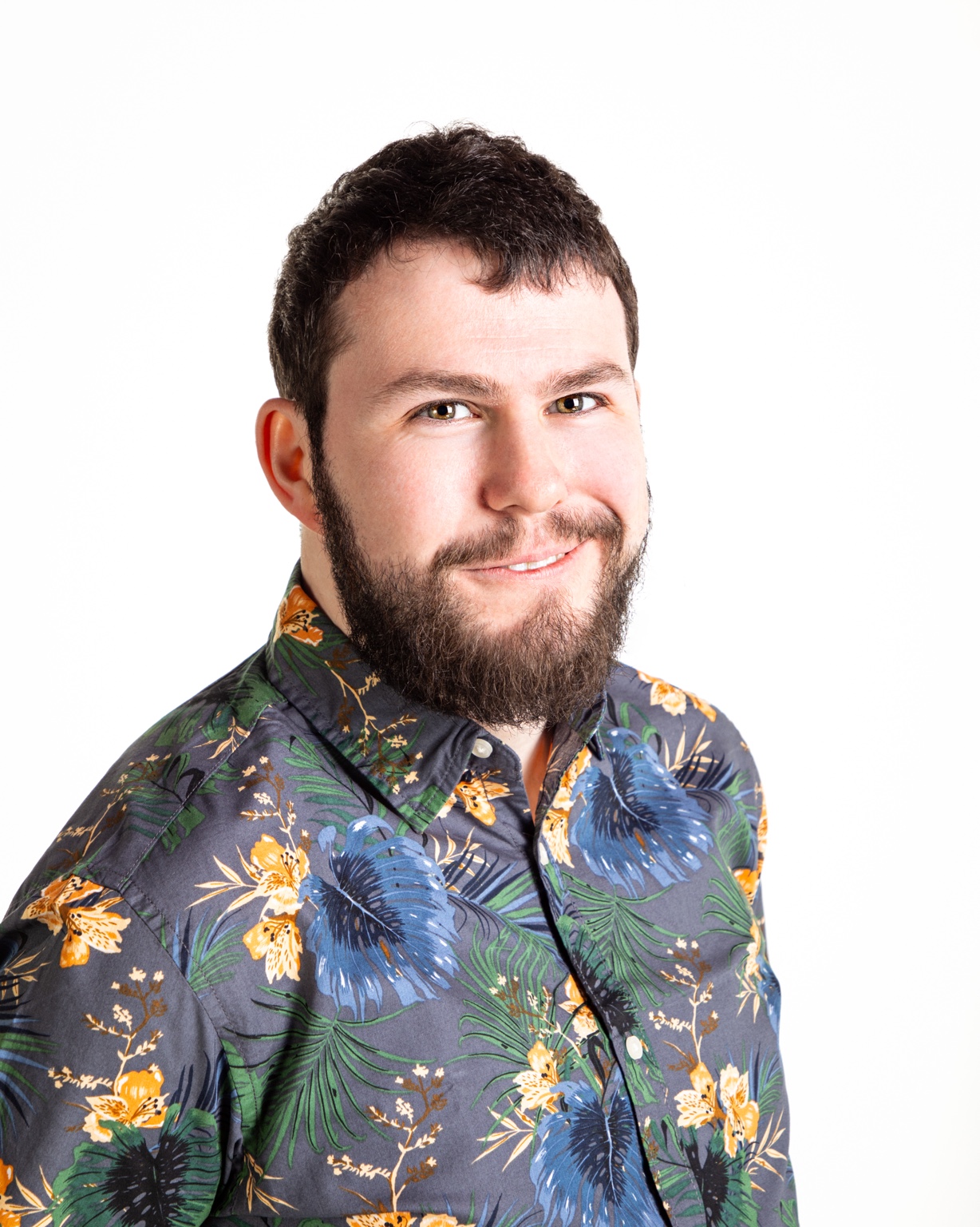 Kristian Matthews-Kennington smiling in a dark floral shirt